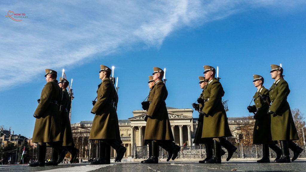 Hungarian soldiers in ceremonial uniforms stand in formation outside the National Museum in Budapest on March 15th, commemorating the 1848 Revolution with official reenactments and speeches.