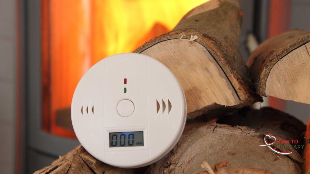 Carbon monoxide detector in a living room near a fireplace
