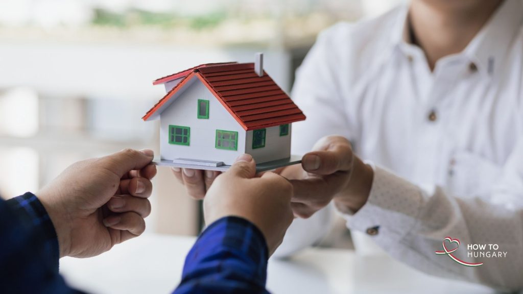 Close-up of two people exchanging a house during property handover, symbolising inheritance and ownership transfer in Hungary.