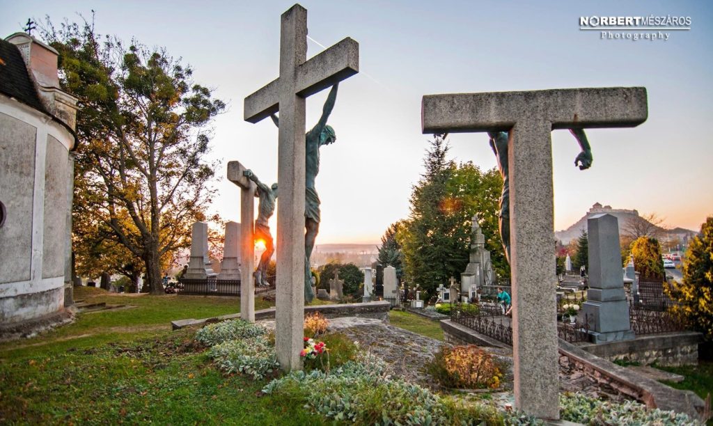 Sunset over the crucifixes at Sümeg Cemetery with the castle in the distance on All Saints’ Day in Hungary. Photo © Norbert Mészáros Photography.