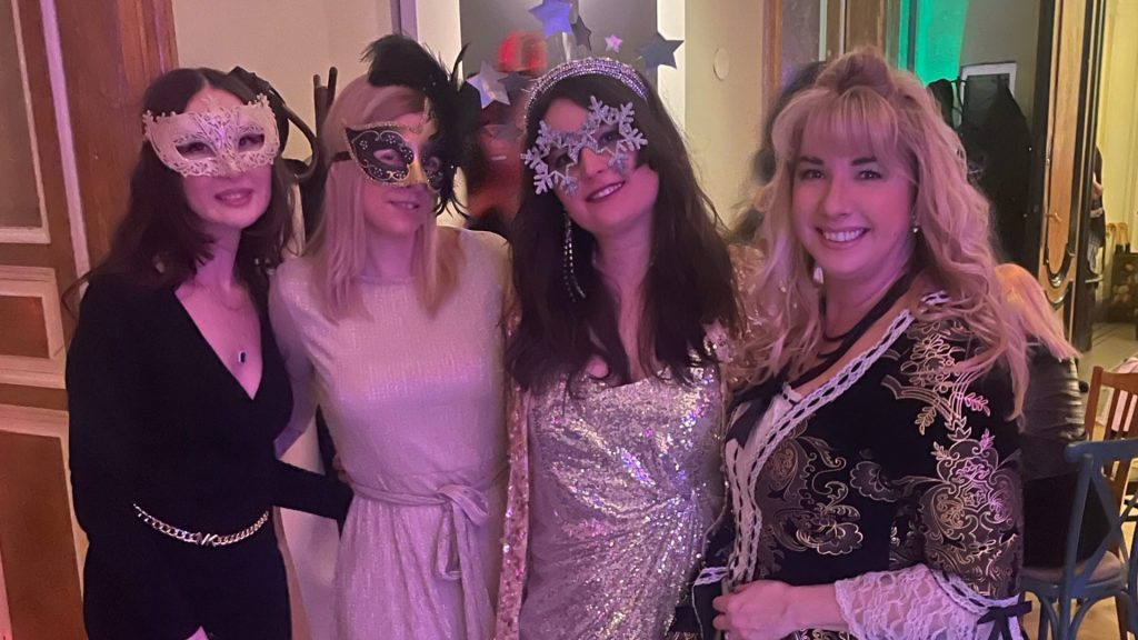 Anikó with three friends wearing masks at a Farsang party at Brody House in Budapest