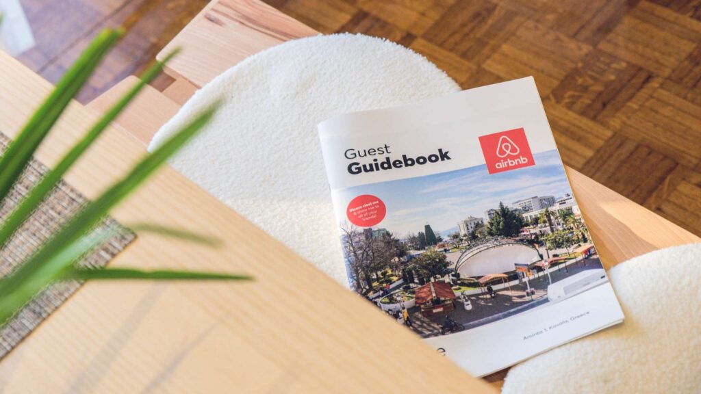 bnb guest guidebook open on a table in a Budapest flat, the kind of short-term rental the Castle District plans to ban from 2028.
